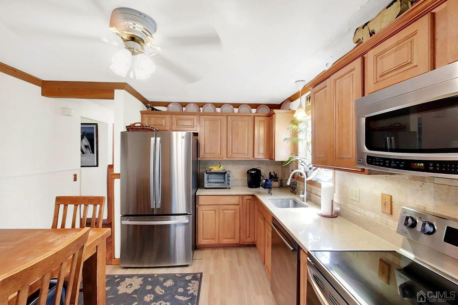 137 Kimberly Road Colonia, NJ 07067 - Photo 14 of 39 a kitchen with stainless steel appliances a stove a sink a microwave and refrigerator