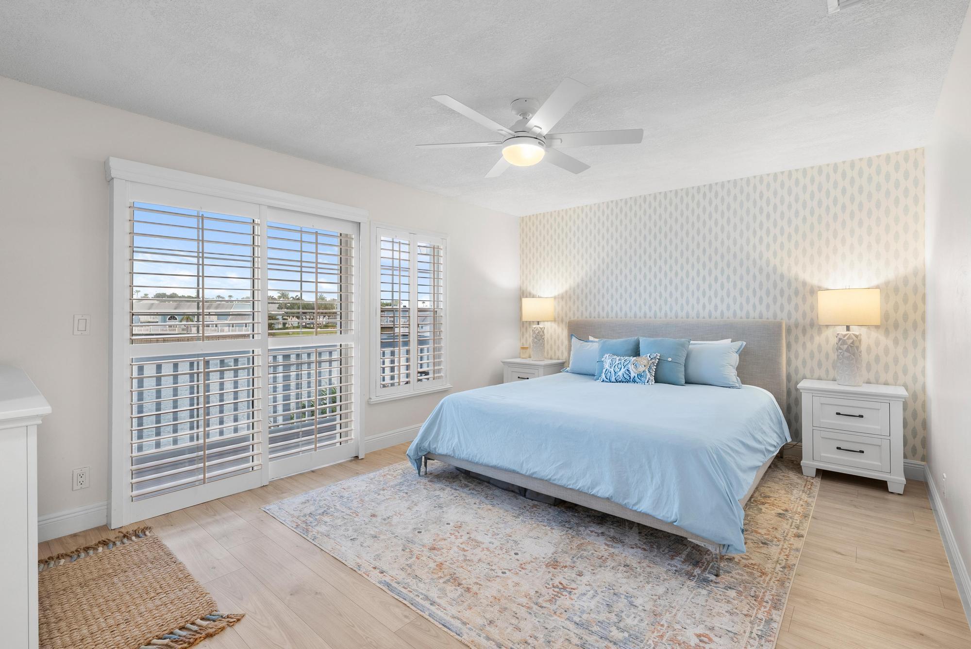 1219 Ocean Dunes Circle Jupiter, FL 33477 - Photo 13 of 35 a bedroom with a large bed and a window
