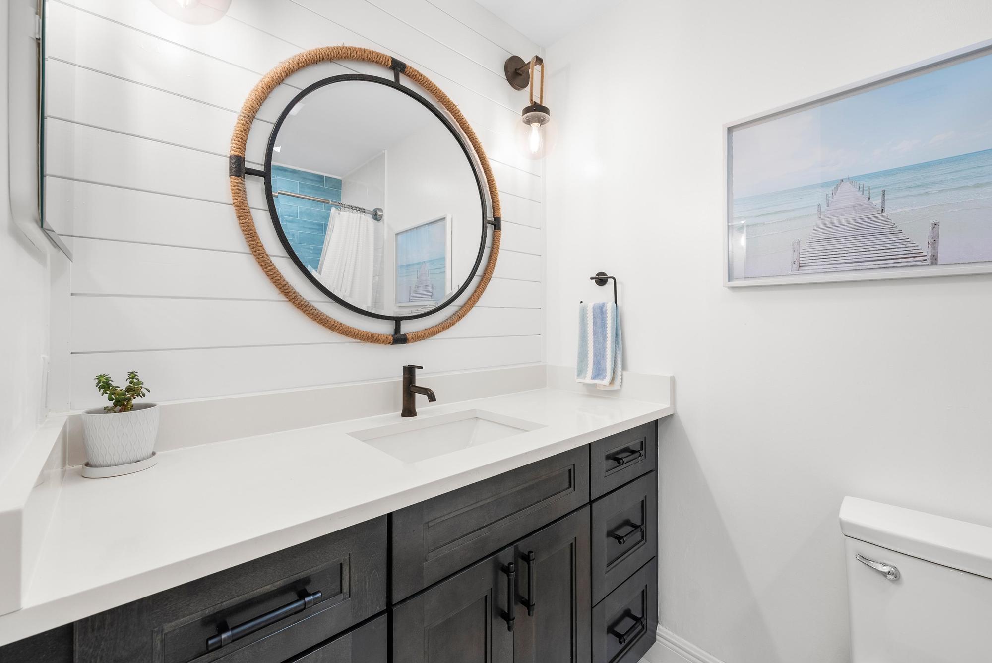 1219 Ocean Dunes Circle Jupiter, FL 33477 - Photo 18 of 35 a bathroom with a sink and a mirror