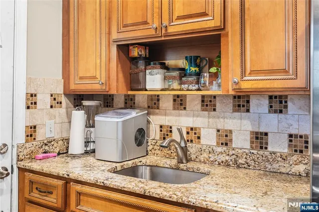 a kitchen with sink and cabinets