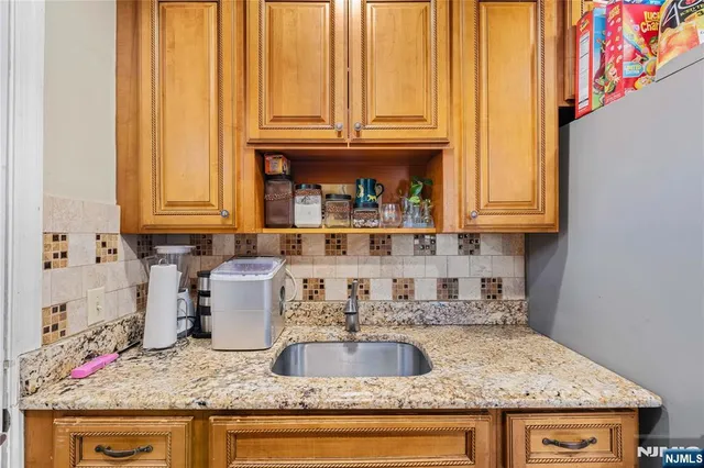 a kitchen with granite countertop a sink and cabinets