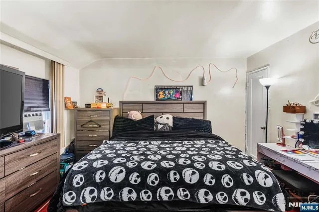 a bedroom with a bed and a dresser in it