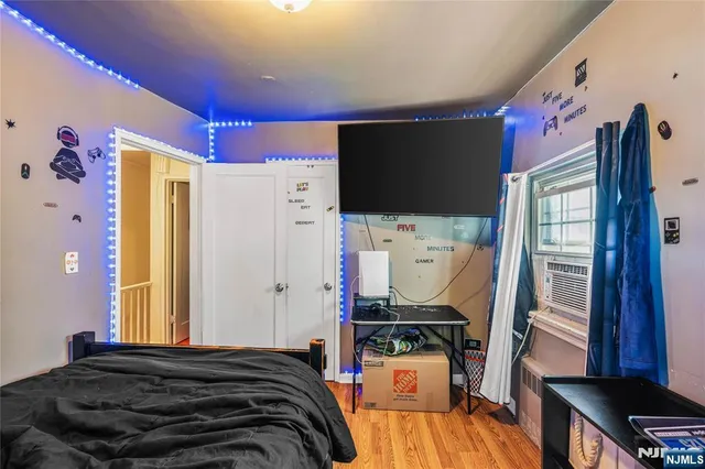 a bedroom with a bed and flat screen tv