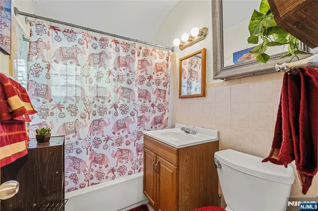 a bathroom with a sink toilet and a shower curtain