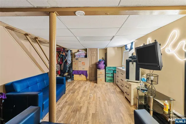 a view of a living room with furniture and wooden floor