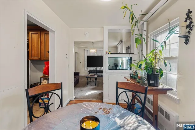 a living room with furniture a flat screen tv and a table