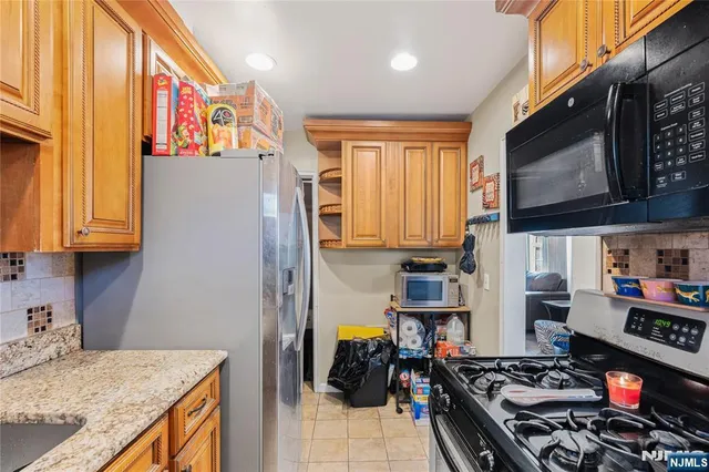 a kitchen with stainless steel appliances granite countertop a stove and a refrigerator