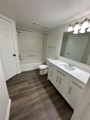 a bathroom with a sink vanity and mirror