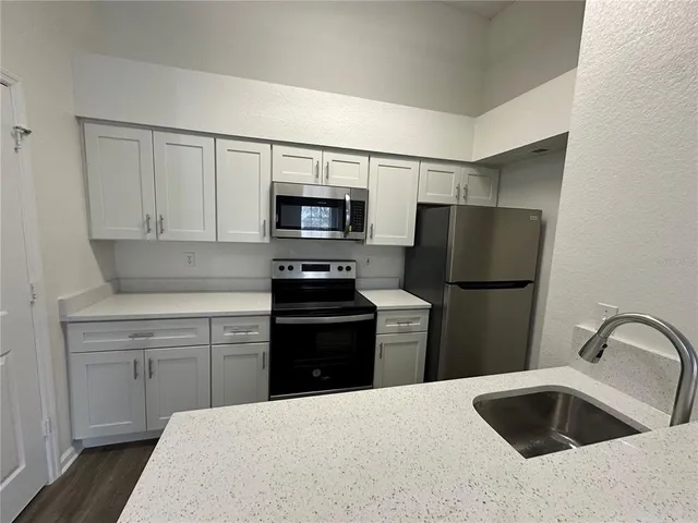 a kitchen with a refrigerator sink and microwave