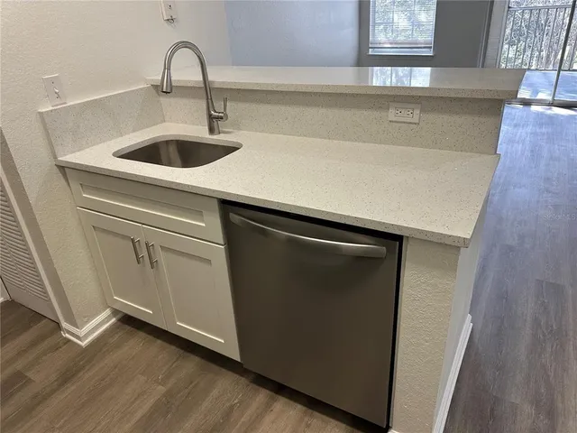 a close view of a sink a washer and dryer