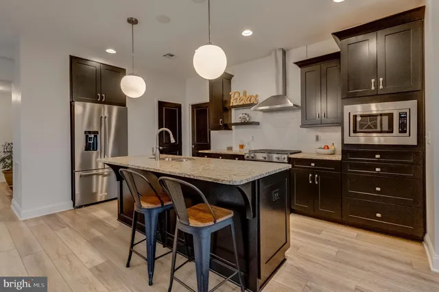 a kitchen with a table chairs and wooden floor