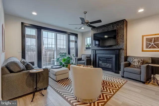 a living room with fireplace furniture and a flat screen tv
