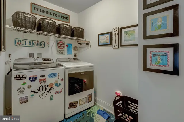 a utility room with stainless steel appliances a stove a sink and a refrigerator