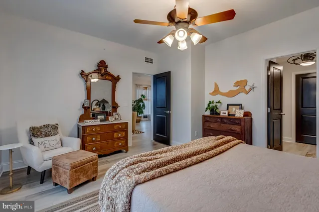 a bedroom with bed and a chandelier