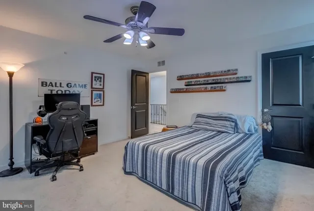 a bedroom with bed and a chandelier