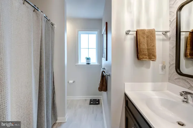 a bathroom with a sink vanity and a mirror