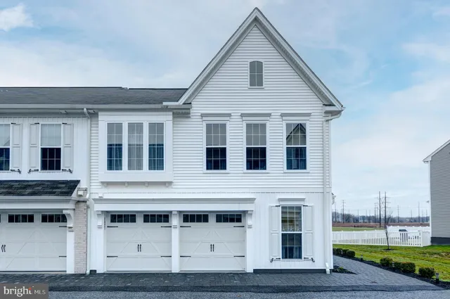 a view of a white house with large windows