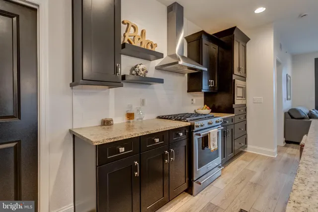 a kitchen with stainless steel appliances granite countertop a stove a sink and a refrigerator