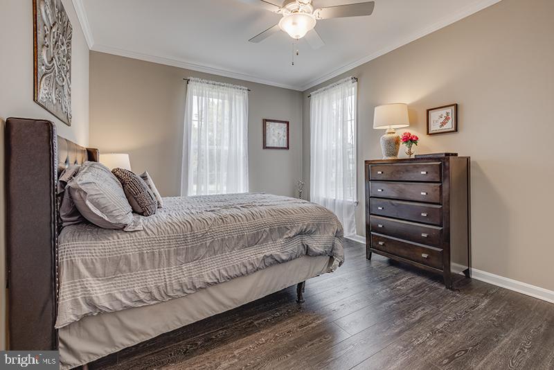 38 High Ridge Road Felton, DE 19943 - Photo 23 of 51 a bedroom with a bed and a chandelier
