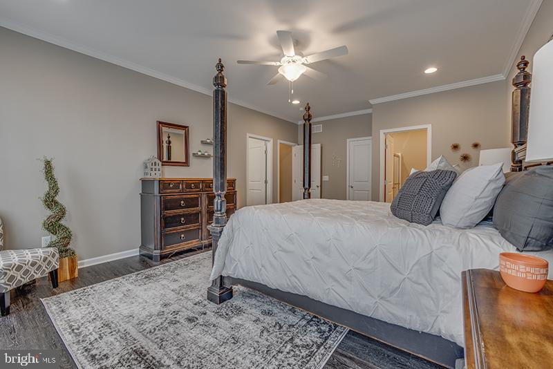 38 High Ridge Road Felton, DE 19943 - Photo 29 of 51 a bed room with a bed and a chandelier