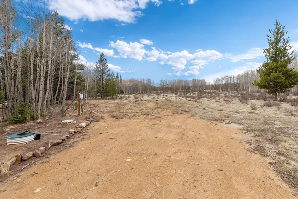 a view of a yard with wooden fence
