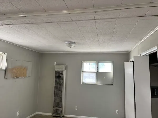 a view of a room with an empty space and window