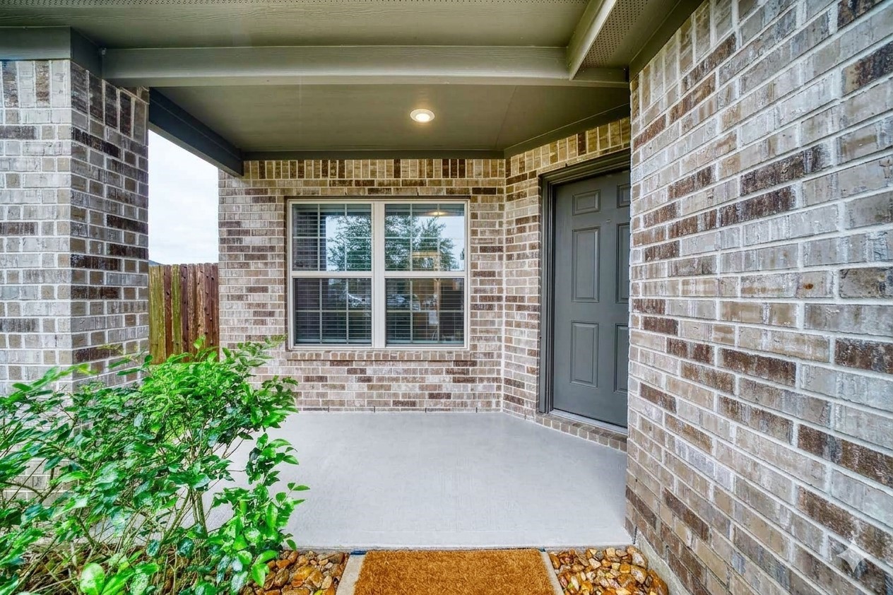 184 Kelly Street Angleton, TX 77515 - Photo 5 of 19 Welcome home! This charming covered front porch offers a sheltered entryway for guests and excellent curb appeal. The classic brick exterior and modern front door provide a timeless first impression.