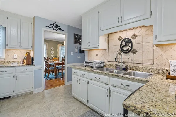 a kitchen with cabinets and window