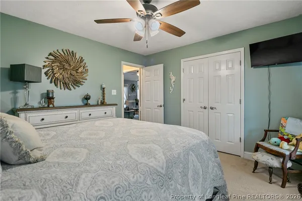a bedroom with a large bed and a chandelier