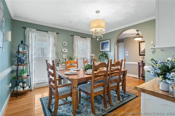 a view of a dining room with furniture and chandelier