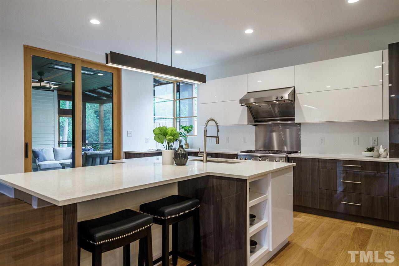 1619 Lorraine Road Raleigh, NC 27607 - Photo 11 of 30 The Custom Marvin Sliding Door opens to a delightful Screened Porch that, with its two ceiling radiant heating easily functions as a three season room. Staged now with two sofas, but there is plenty of room for dining and seating.