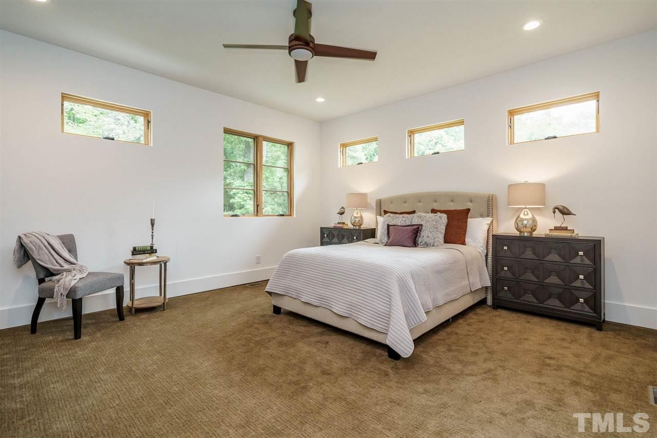 1619 Lorraine Road Raleigh, NC 27607 - Photo 16 of 30 Large Owner's Suite is located at the back at the home off the tranquil backyard. This large Bedroom offers plenty of space for large furniture. Custom windows were placed for maximum privacy. Stainmaster carpet makes the room cozy and extra quiet.
