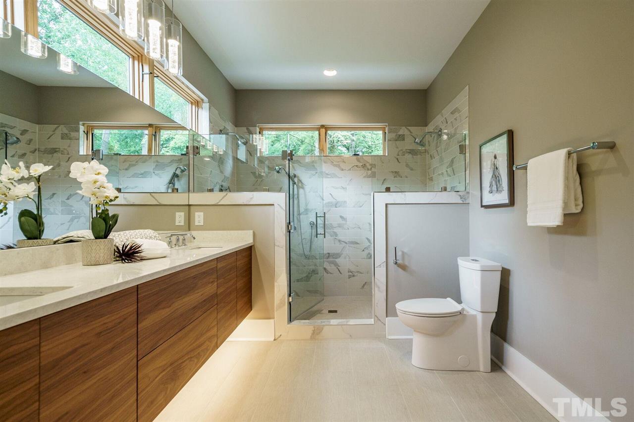 1619 Lorraine Road Raleigh, NC 27607 - Photo 18 of 30 Custom windows placed for natural light and ultimate privacy. The home is served by a Tankless Water Heater with On-Demand Hot Water.