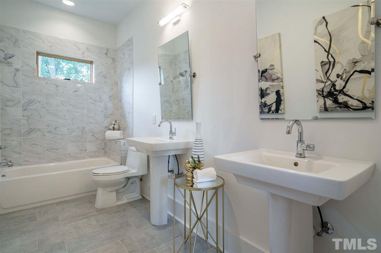 1619 Lorraine Road Raleigh, NC 27607 - Photo 23 of 30 This large Second Floor Full Bathroom serves two Bedroom and the Bonus Room. Two Pedestal Sinks, Sleek and calming finishes.