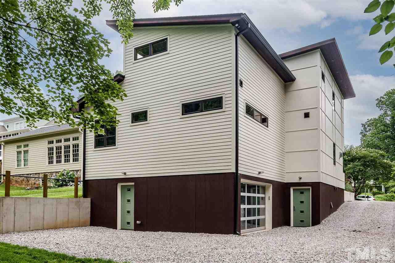 1619 Lorraine Road Raleigh, NC 27607 - Photo 27 of 30 Dramatic downlighting from the Brazilian Teak Soffits; Rain Wall construction technology used on Tower Wall; Exterior is Brick and Hardiplank with Brazilian Teak (rot and insect resistant) Soffits; Walkout Basement, Encapsulated Crawl Space.