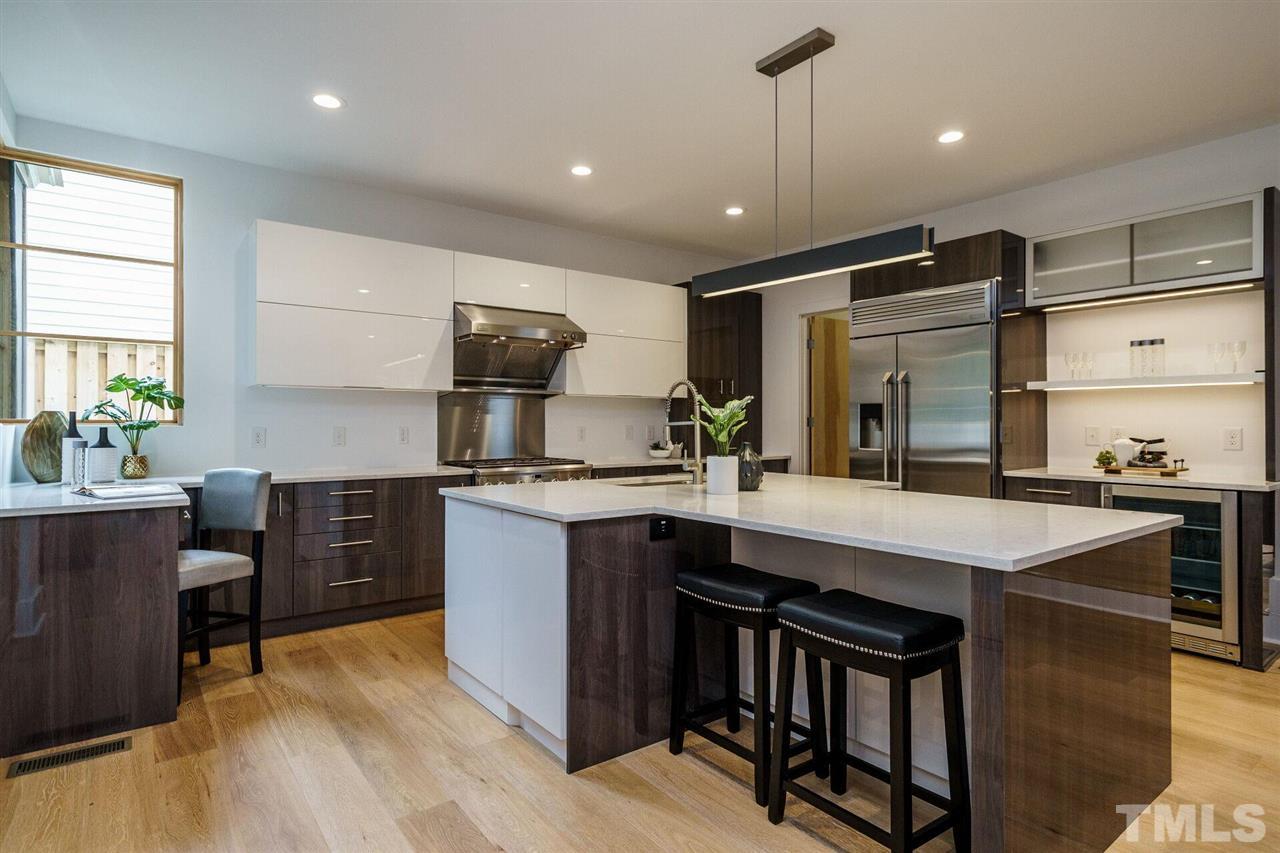 1619 Lorraine Road Raleigh, NC 27607 - Photo 10 of 30 LED lighting, European-style Upper Cabinets, Under Cabinet Lighting, A suite of GE Mongogram appliances including a six-burner Gas range and pro-capacity Vent Hood w/ 10" heated air return, Beverage station with custom liquor drawer. Corner Window