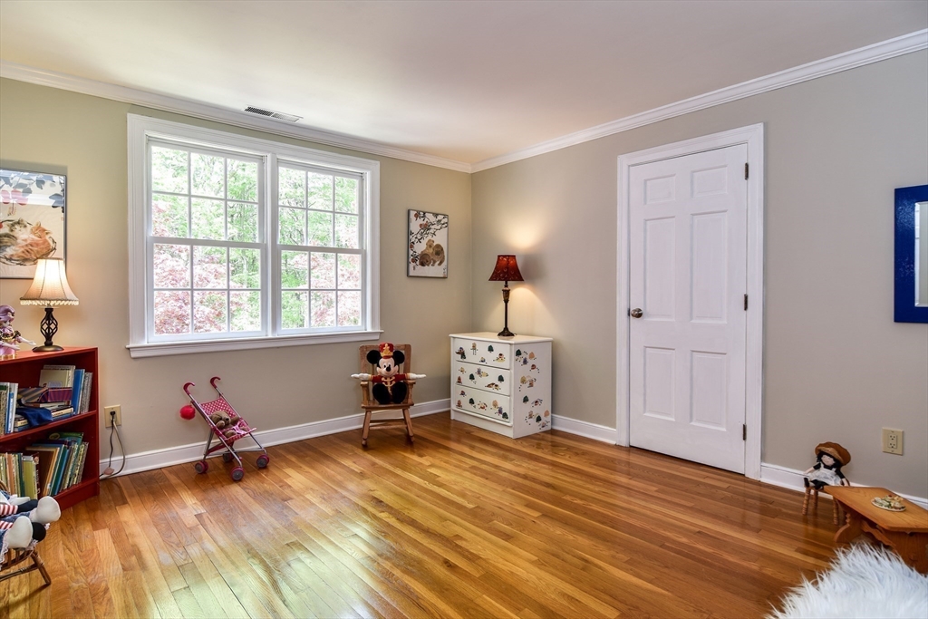 114 Hunters Ridge Road Concord, MA 01742 - Photo 27 of 38 a bedroom with a bed and a wooden floor