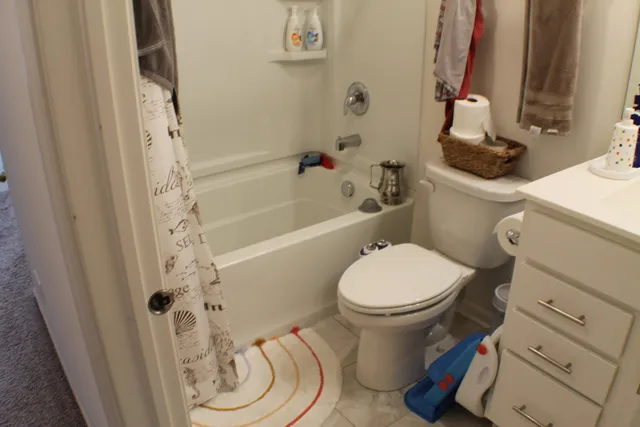 a bedroom with a bed and chair