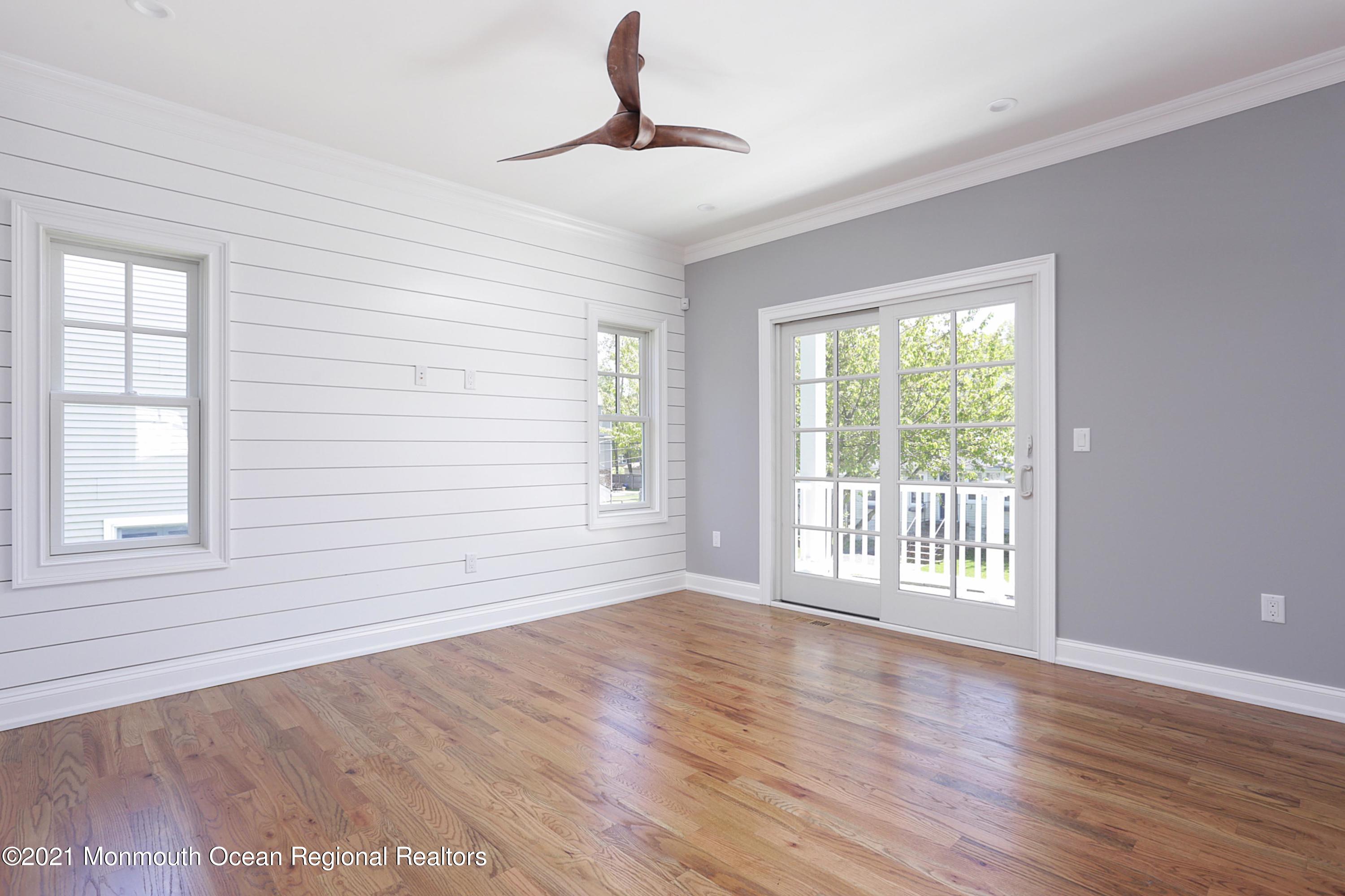 1 Meadowbrook Avenue Rumson, NJ 07760 - Photo 4 of 7 a view of an empty room with wooden floor and a window