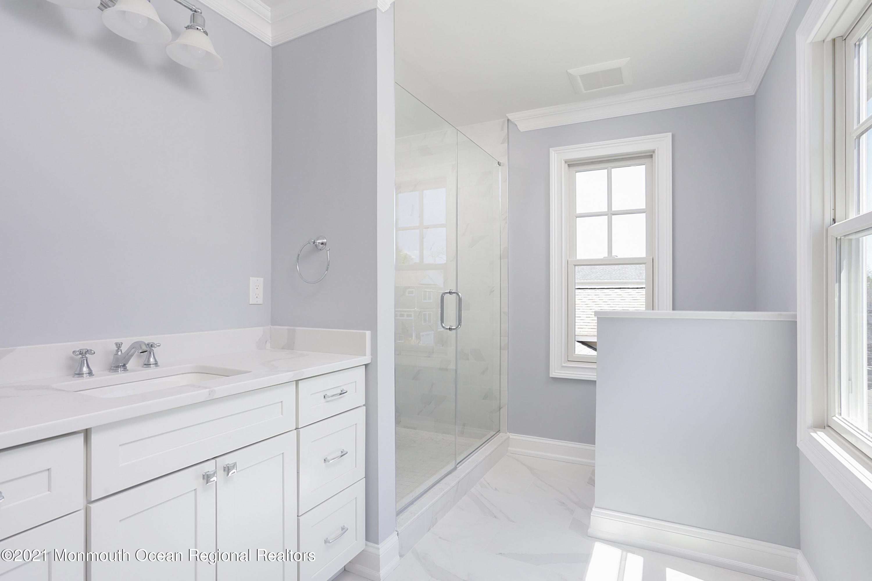 1 Meadowbrook Avenue Rumson, NJ 07760 - Photo 5 of 7 a bathroom with a granite countertop sink a mirror and a shower