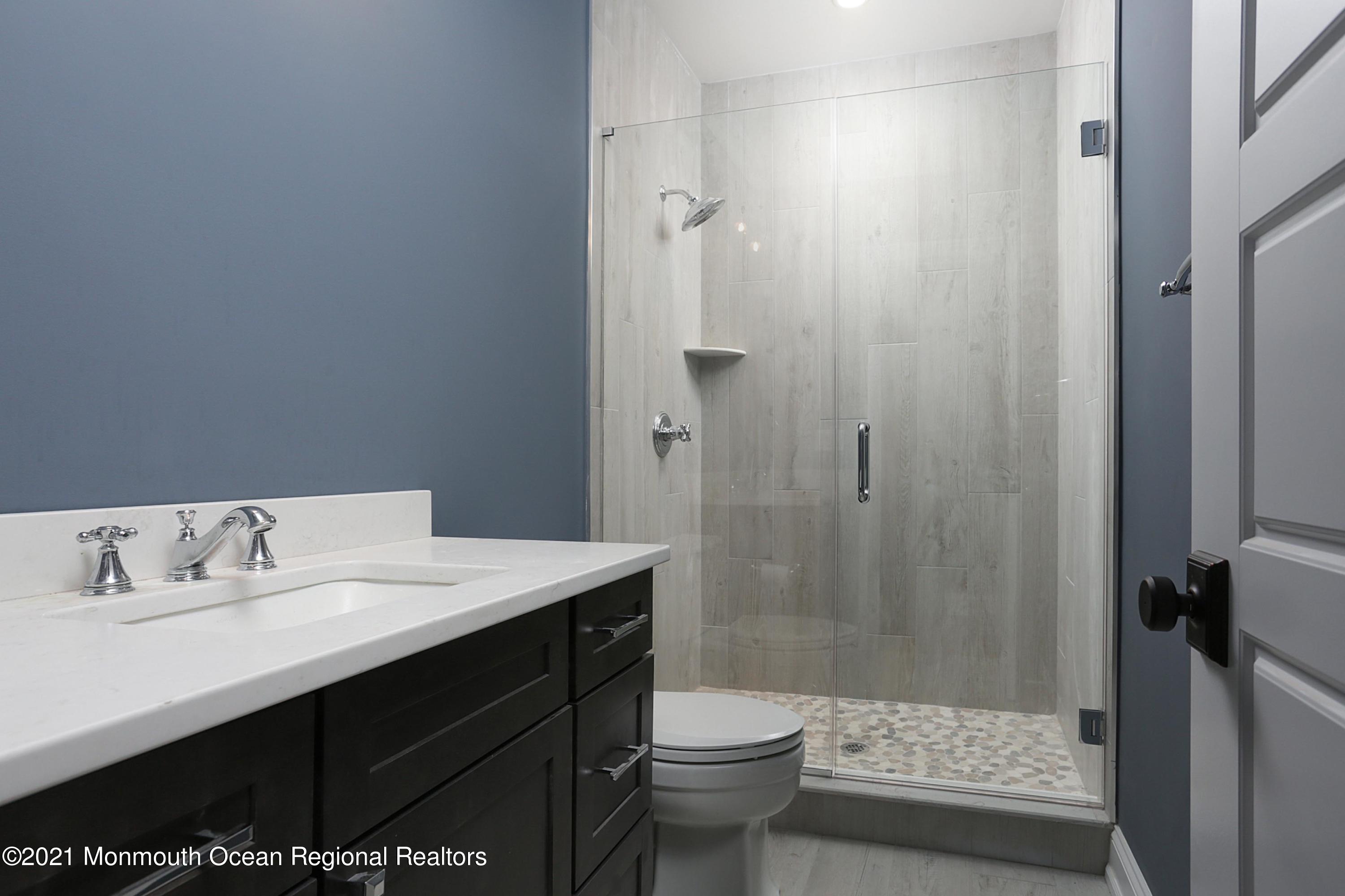 1 Meadowbrook Avenue Rumson, NJ 07760 - Photo 6 of 7 a bathroom with a sink a toilet and shower