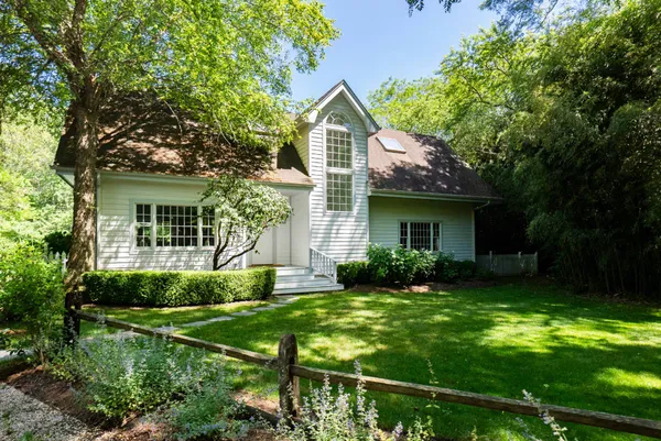 a view of a house with yard and a garden