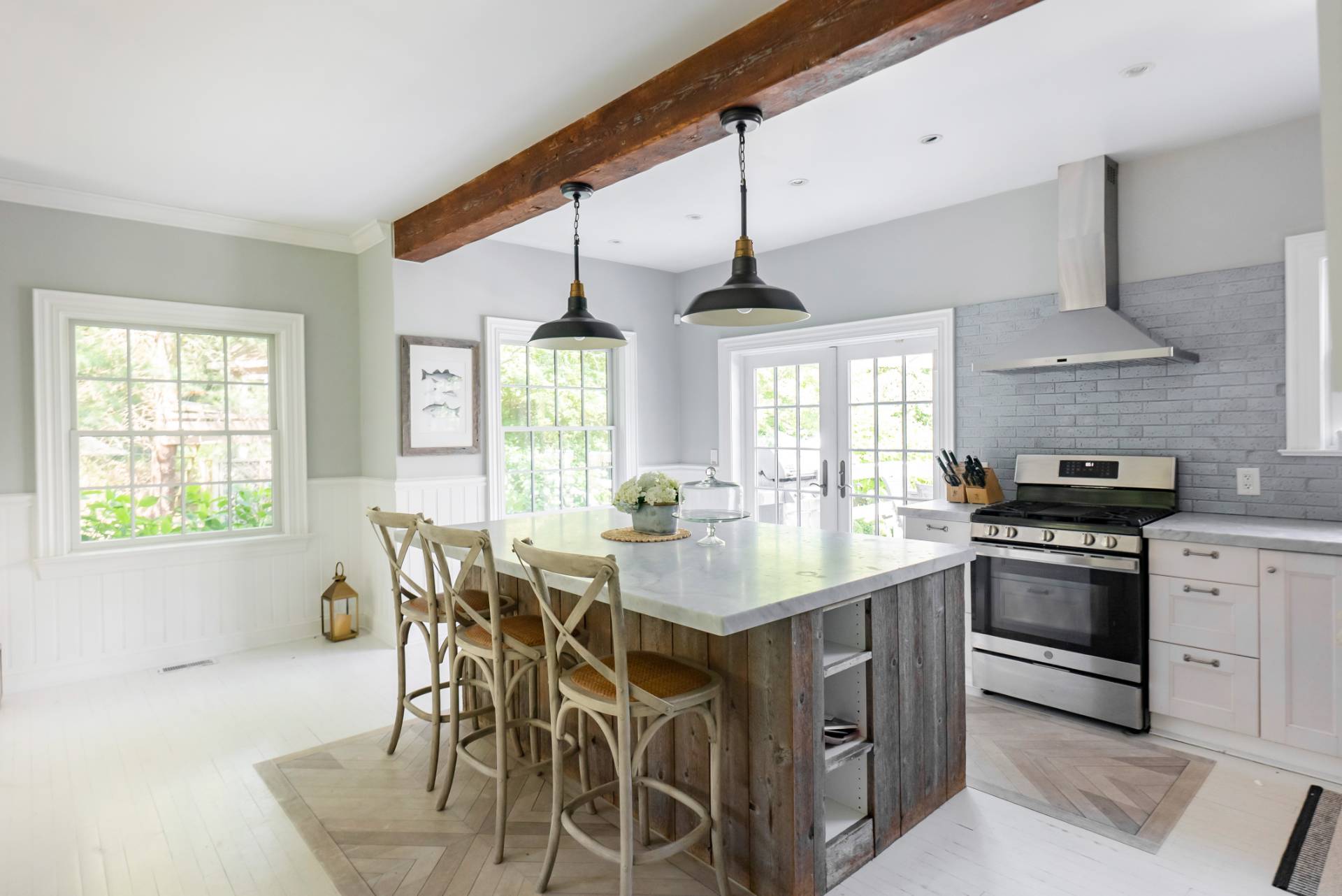 29 Meadows East Bridgehampton, NY 11932 - Photo 2 of 15 a kitchen with stainless steel appliances a sink a stove and chairs