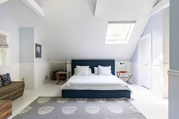 a bedroom with bed and window