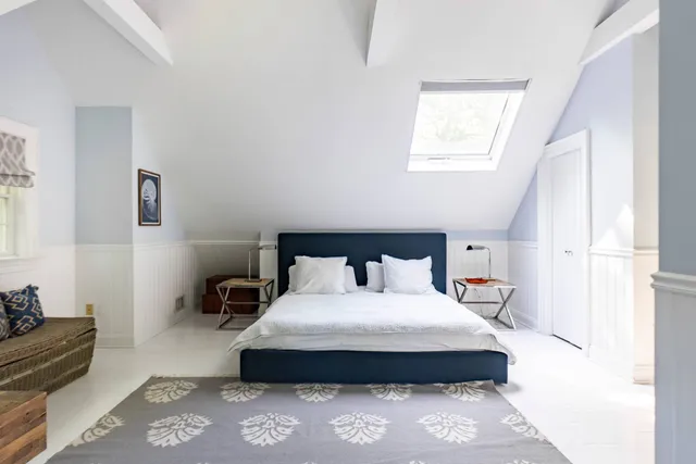 a bedroom with bed and window