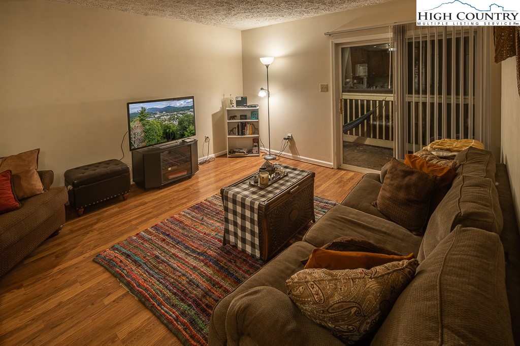 800 Meadowview Drive, Unit 6 Boone, NC 28607 - Photo 2 of 19 a living room with furniture and a flat screen tv