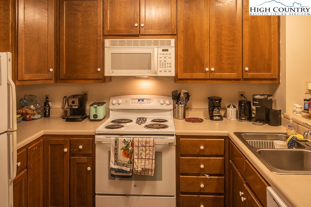 800 Meadowview Drive, Unit 6 Boone, NC 28607 - Photo 5 of 19 a kitchen with a sink stove and cabinets
