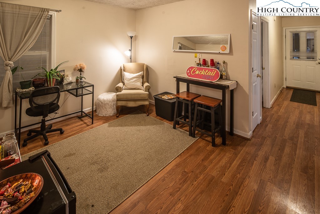 800 Meadowview Drive, Unit 6 Boone, NC 28607 - Photo 6 of 19 a bed room with furniture and a wooden floor