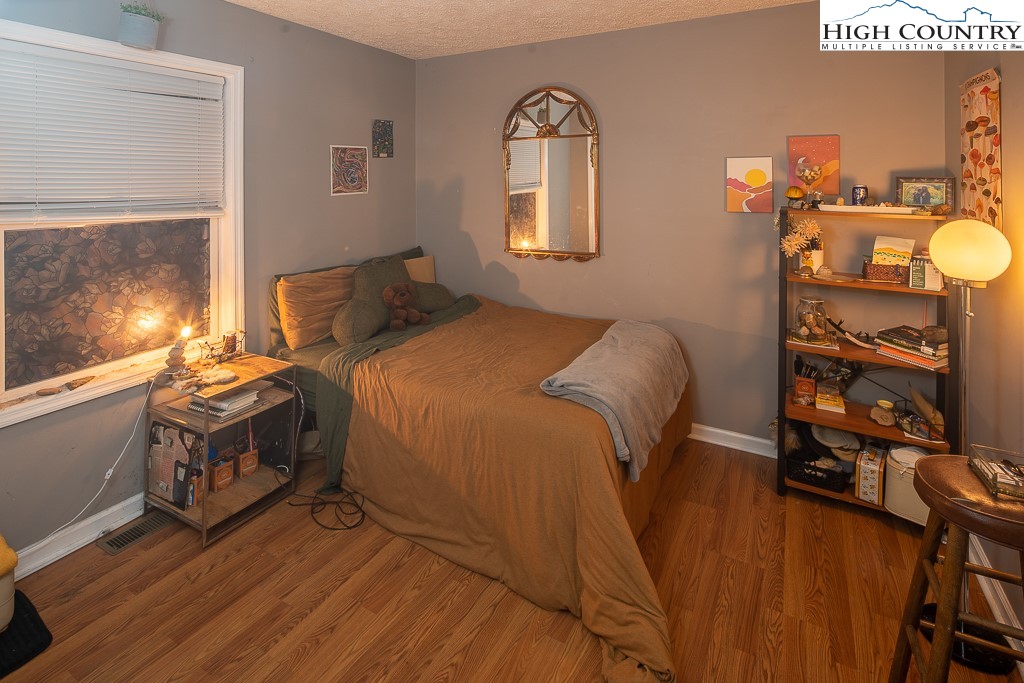 800 Meadowview Drive, Unit 6 Boone, NC 28607 - Photo 9 of 19 a spacious bedroom with a bed and a flat tv screen on the dresser