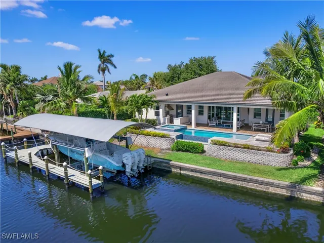 a aerial view of a house with swimming pool and a yard